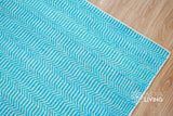 Aqua blue wool rug under a coffee table