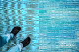Aqua blue chevron wool rug styled in a modern living room