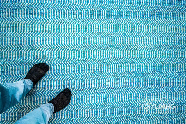 Aqua blue chevron wool rug styled in a modern living room