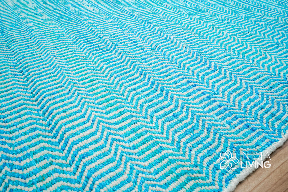 Aqua blue wool rug texture close-up showing handwoven chevron weave