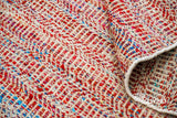 Multi blend red chevron wool rug styled in a living room