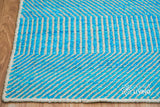 Aqua blue wool rug texture close-up showing handwoven wavy weave