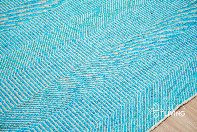 Aqua blue wavy stripe wool rug styled in a modern living room