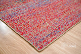 Multi blend red flatweave rug in a bedroom setting