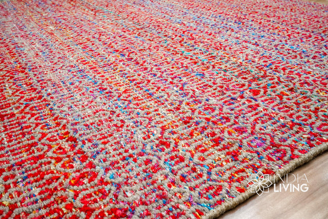 Multi blend red wool rug styled in a living room