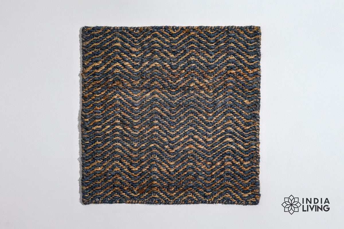 Handwoven herringbone rug shown in a bedroom setting