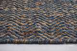 Bluish grey flatweave rug corner detail showing edge binding