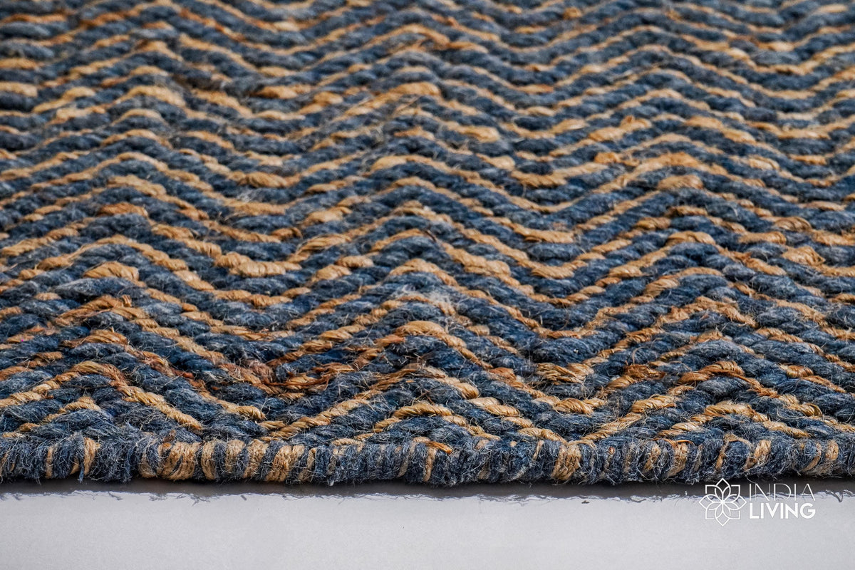 Bluish grey flatweave rug corner detail showing edge binding