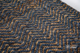 Bluish grey herringbone flatweave rug styled in a living room