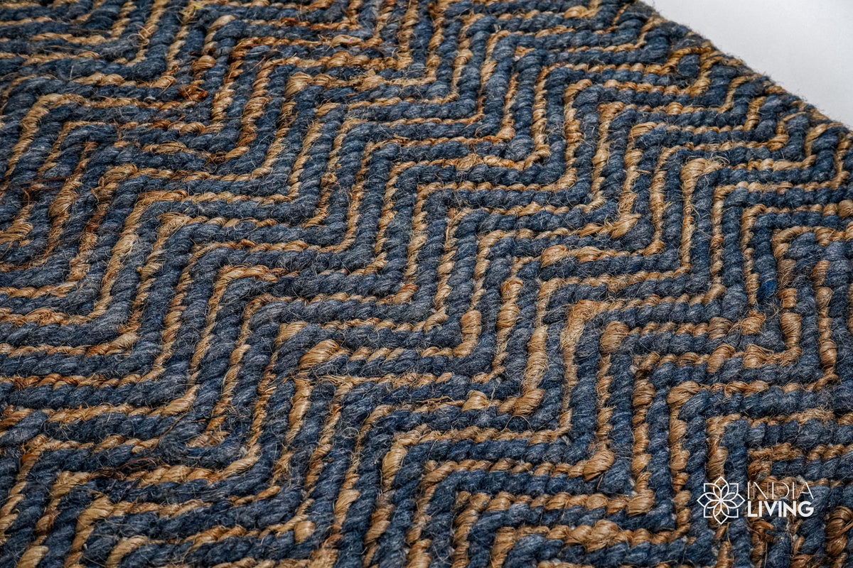 Bluish grey herringbone flatweave rug styled in a living room