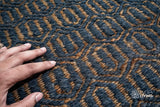 Bluish grey diamond rug corner detail showing edge binding
