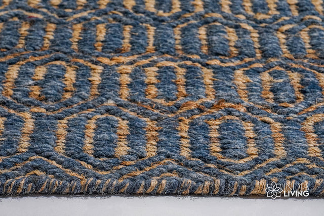 Bluish grey diamond flatweave rug styled in a living room