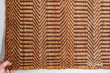 Handwoven chevron rug shown in a bedroom setting