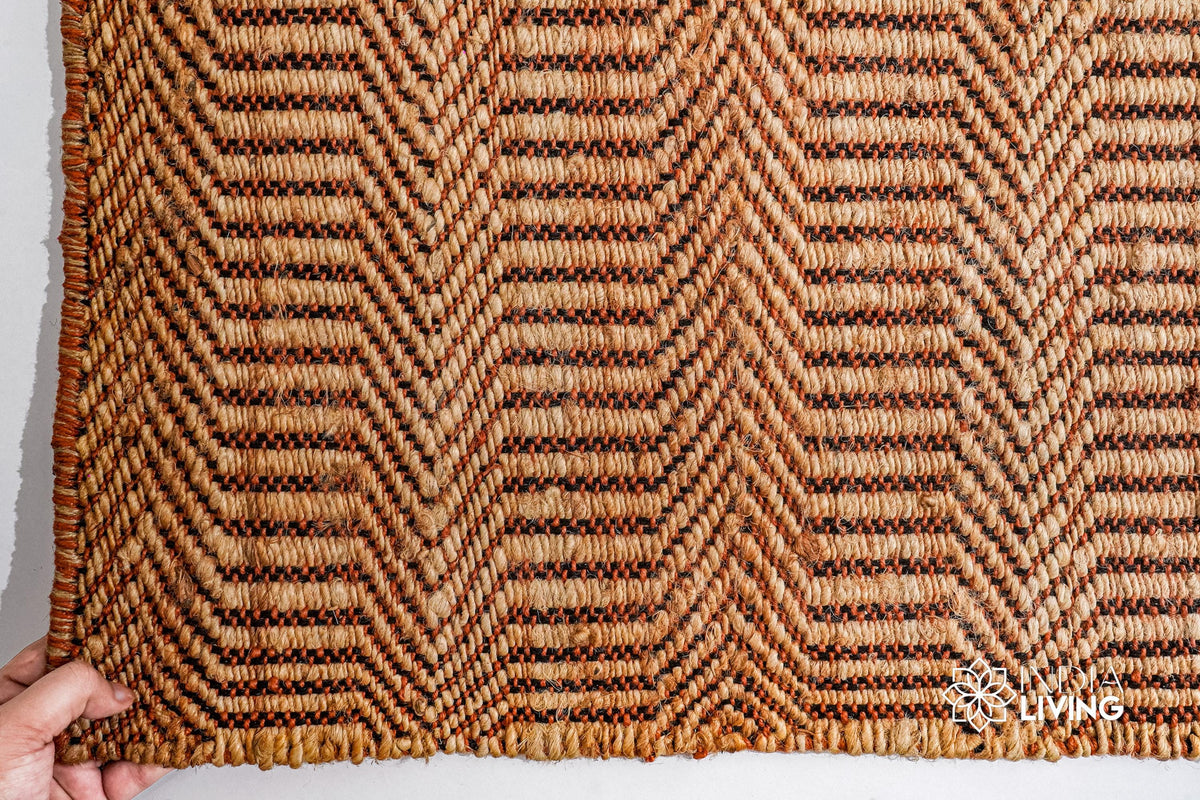 Handwoven chevron rug shown in a bedroom setting