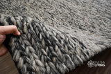 Handwoven grey wool rug in a modern living room