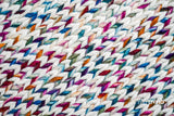 Rainbow rug placed under furniture in nursery