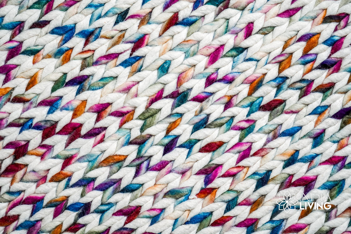 Rainbow rug placed under furniture in nursery
