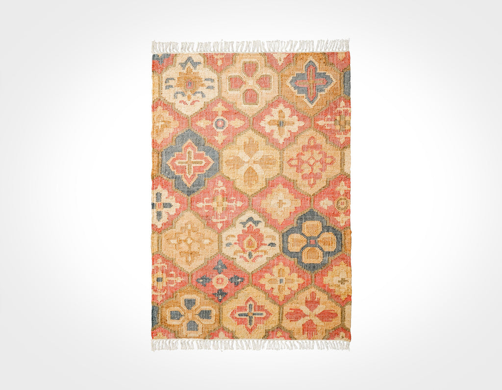 May include: A rectangular rug with a geometric pattern in shades of red, orange, brown, and blue. The rug has a fringe border.