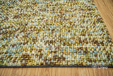 Green wool rug styled in a living room