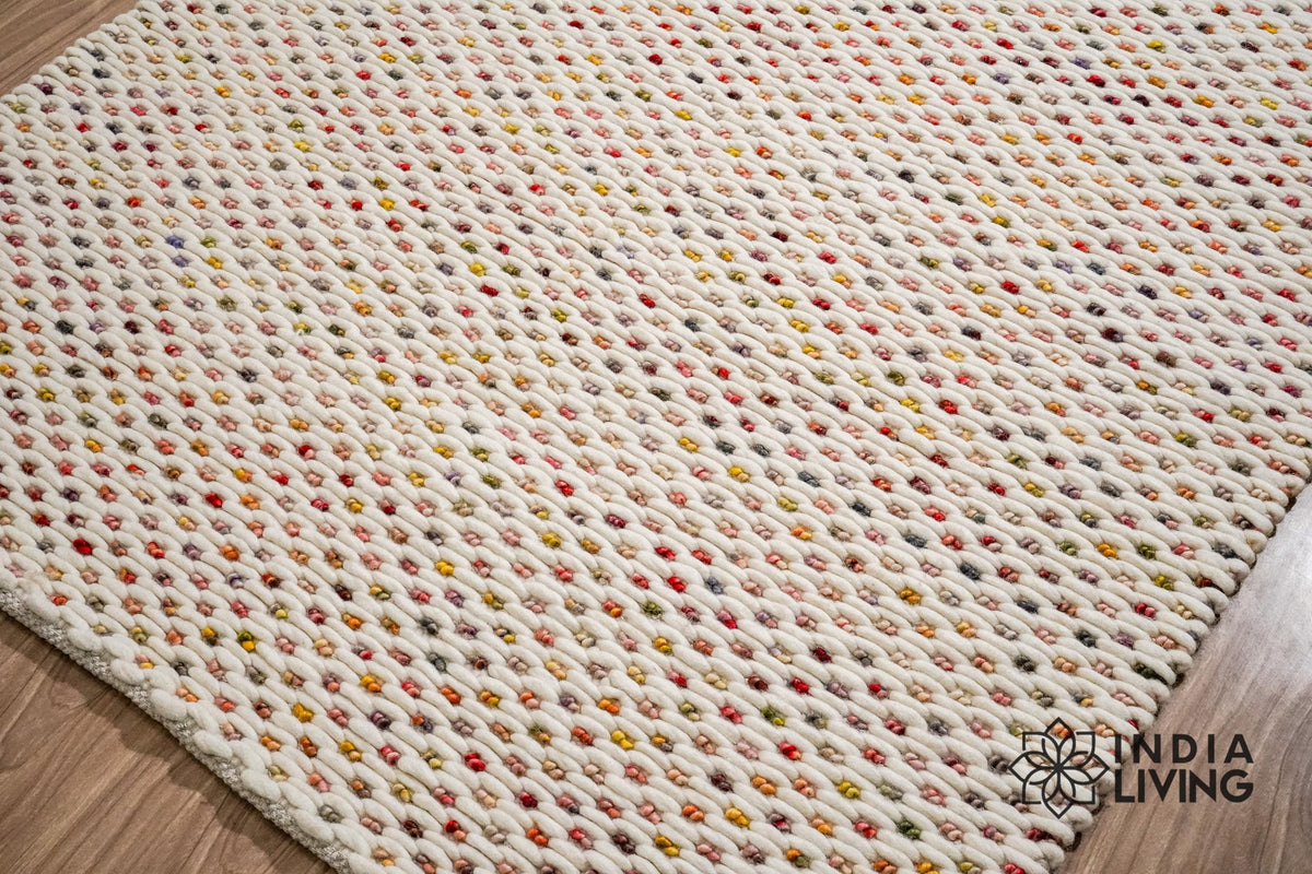 Ivory wool rug styled with furniture in room