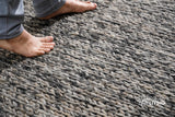 Close-up of cable knit weave texture on chunky wool rug