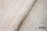 Ivory cream wool rug in a bedroom setting