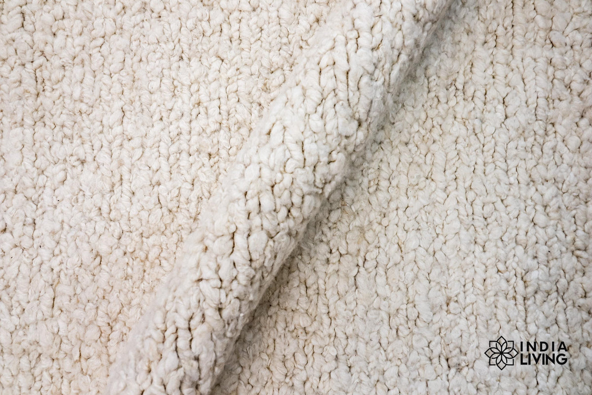 Ivory cream wool rug in a bedroom setting