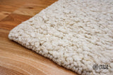 Full room view with ivory cream wool rug