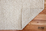 Ivory wool rug shown styled with furniture