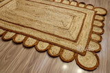 Close-up of scalloped edge on brown jute rug
