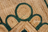 Hand braided dark green rug shown in an entryway setting