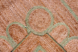 Close-up of scalloped edge detail on pistachio green jute runner