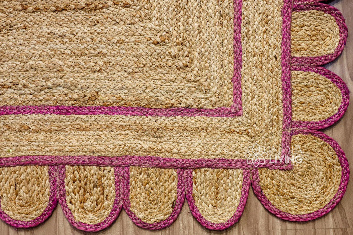 Pink jute runner edge close-up highlighting scallop stitching