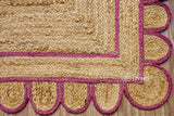 Pink jute runner edge close-up highlighting scallop stitching