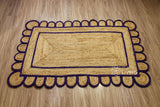 Purple jute runner edge close-up highlighting scallop stitching