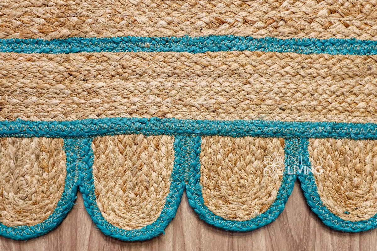 Teal blue jute runner edge close-up highlighting scallop stitching