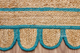 Teal blue jute runner edge close-up highlighting scallop stitching