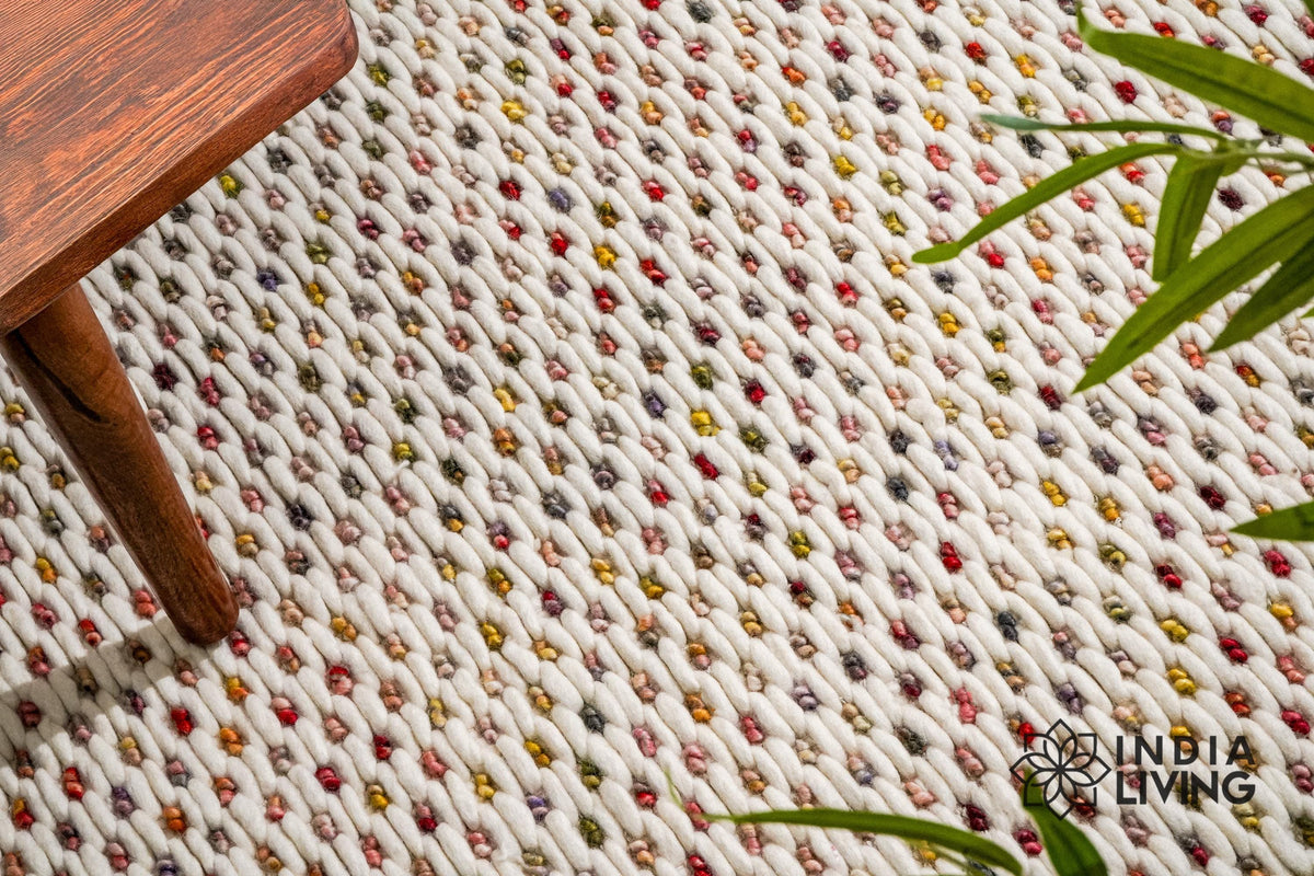Ivory wool rug styled in a living room