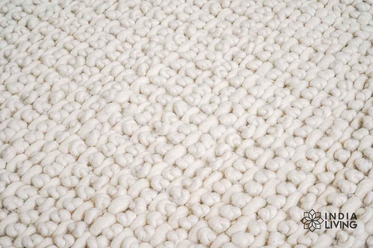Ivory chunky wool rug styled with minimalist decor