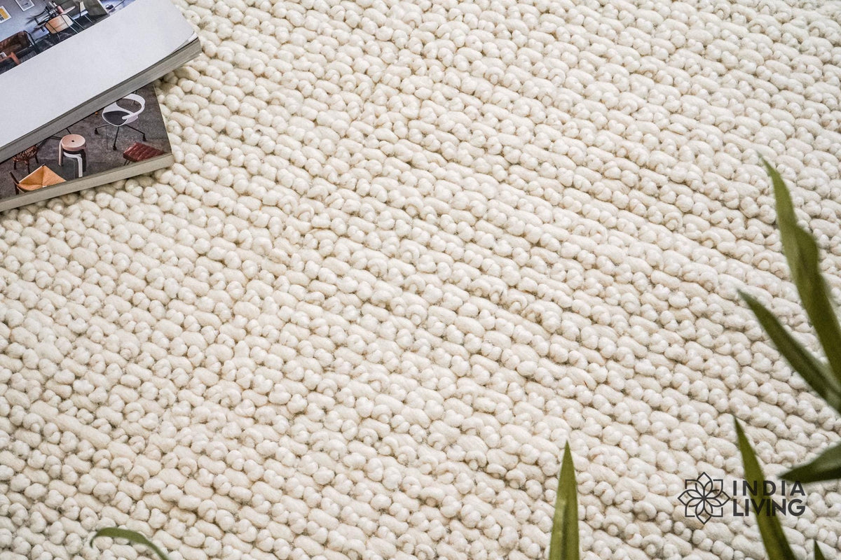 Chunky ivory rug corner detail showing looped pattern