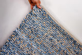 Denim rag rug corner detail showing edge binding
