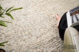 Taupe grey chunky wool rug texture close-up in natural light
