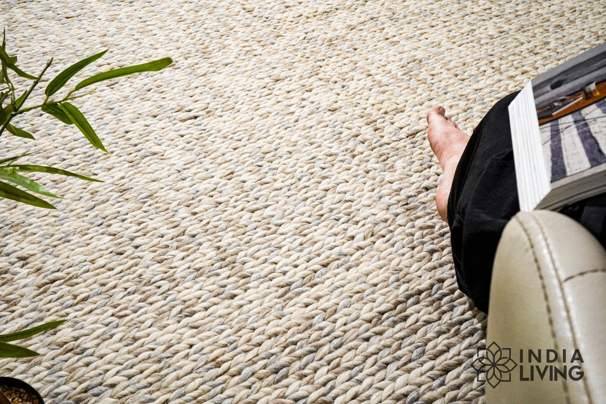 Taupe grey chunky wool rug texture close-up in natural light