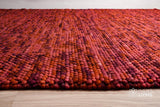Close-up of terracotta wool rug chunky loop pile