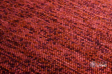 Terracotta wool rug placed under furniture in a living space