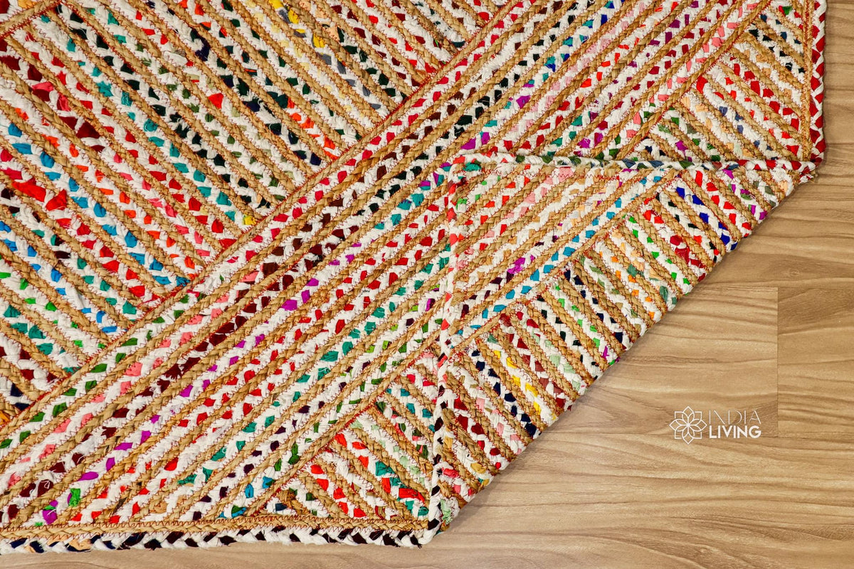 Hand braided rainbow rug shown in a bedroom setting