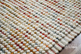 Rainbow blended chunky white wool rug flat view