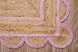 Overhead view of light pink jute runner on wood flooring