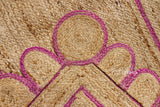 Close-up of scalloped edge detail on pink jute runner