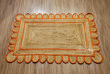 Orange scallop edge jute rug, flat lay view